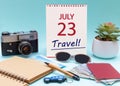 Travel planning, vacation trip - Calendar with the date 23July glasses notepad pen camera cash passports.