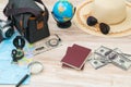 Travel preparation : compass, money, passport, road map ,hat,sunglasses,magnifying glass on wooden table . Royalty Free Stock Photo