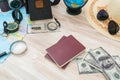 Travel preparation : compass, money, passport, road map ,hat,sunglasses,magnifying glass on wooden table . Royalty Free Stock Photo