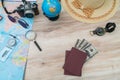 Travel preparation : compass, money, passport, road map ,hat,sunglasses,magnifying glass on wooden table . Royalty Free Stock Photo