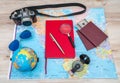 Travel preparation : compass, money, passport, road map ,sunglasses,magnifying glass ,camera ,cloth ,book on wooden table . Royalty Free Stock Photo