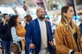 Travel, queue and smile with black man in airport for flight, vacation and immigration. Happy, international and customs Royalty Free Stock Photo