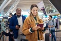 Travel, queue and ticket with woman in airport for vacation, international trip and tourism. Holiday, luggage and Royalty Free Stock Photo