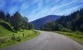 Travel road on the field with green grass and blue sky with clouds on the farm in beautiful summer sunny day. Clean, idyllic, lan Royalty Free Stock Photo