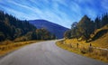 Travel road on the field with yellow autumn grass and blue sky with clouds on the farm in beautiful summer sunny day. Clean, idyll Royalty Free Stock Photo