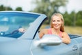 Happy young woman driving convertible car Royalty Free Stock Photo