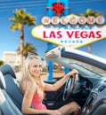 Happy woman driving convertible car at las vegas