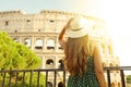 Travel in Rome. Back view of beautiful girl visiting Colosseum landmark at sunset. Summer holidays in Italy Royalty Free Stock Photo