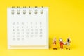 Travel schedule or reminder calendar concept, miniature people group of young lady with luggages or baggage beside small clean Royalty Free Stock Photo