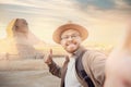Travel Selfie photo man in hat background pyramid of Egyptian Giza and Sphinx, sunset Cairo, Egyp Royalty Free Stock Photo
