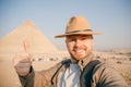 Travel selfie photo tourist man in hat background pyramid of Egyptian Giza, sunset Cairo, Egypt