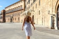 Travel in Sicily. Back view of young beautiful woman walking near Royal Palace of Palermo, Italy Royalty Free Stock Photo