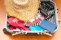 Travel suitcase with clothes on wooden floor Royalty Free Stock Photo