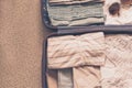 Open traveler`s bag with clothing, accessories and passport, travel and vacations concept Royalty Free Stock Photo