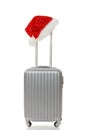 Travel suitcase with Santa hat on handle Royalty Free Stock Photo