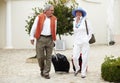 Travel, suitcase and senior couple walking on vacation in a holiday location happy in retirement together at a hotel Royalty Free Stock Photo