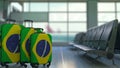 Travel suitcases featuring flag of Brazil. Brazilian tourism conceptual 3D rendering Royalty Free Stock Photo