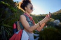 Travel, sunglasses and woman with smartphone in nature for hiking route, gps navigation, or direction. Smile, mobile Royalty Free Stock Photo