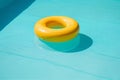 ring float vacation resort sunlight pool rescue circle yellow water. Generative AI.