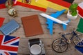 Travel time - passport, camera, flags of different countries, airplane model, little bicycle and suitcase, compass Royalty Free Stock Photo