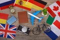 Travel time - passport, camera, flags of different countries, airplane model, little bicycle and suitcase, compass Royalty Free Stock Photo