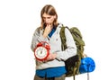 Travel time season. Man backpacker holding clock.