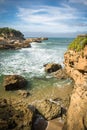 Travel to beautiful scenic colorful view on atlantic turquoise ocean with waves, coastline rocks in blue sky