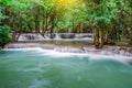 Travel to the beautiful waterfall in tropical rain forest, soft water of the stream in the natural park at Kanchanaburi, Thailand Royalty Free Stock Photo