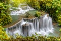 Travel to the beautiful waterfall in tropical rain forest, soft water of the stream in the natural park at Kanchanaburi, Thailand Royalty Free Stock Photo