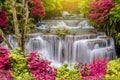 Travel to the beautiful waterfall in tropical rain forest, soft water of the stream in the natural park at Kanchanaburi, Thailand