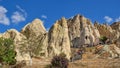 Travel to fairy Cappadocia. Panoramic scenery view to Goreme Open Air Museum with walking foreign visitors tourists