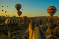 Travel to Goreme, Cappadocia, Turkey. The sunrise in the mountains with a lot of air hot balloons in the sky Royalty Free Stock Photo