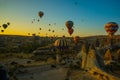 Travel to Goreme, Cappadocia, Turkey. The sunrise in the mountains with a lot of air hot balloons in the sky Royalty Free Stock Photo