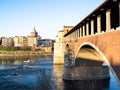 arch of Ponte Coperto bridge and view of Pavia