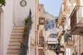 Travel to Italy - backyard of historical street of Taormina, Sicily, facade of ancient buildings
