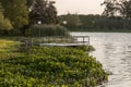 Travel to a portion of river with a natural scenery of sunset over a dock with lights Royalty Free Stock Photo