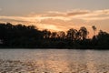 Travel to a portion of river with a natural scenery of sunset over a dock with lights Royalty Free Stock Photo