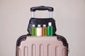 Travel toiletries, small plastic bottles of hygiene products on the suitcase Royalty Free Stock Photo