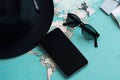 Travel Top view with map and mobile phone hat flat lay for tourism background in blue and teal tone. Royalty Free Stock Photo