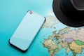 Travel Top view with map and mobile phone hat flat lay for tourism background in blue and teal tone Royalty Free Stock Photo