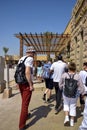 Travel tour group, tourists goes to Karnak Temple. People exploring Egypt. Beautiful Egyptian landmark with hieroglyphics Royalty Free Stock Photo