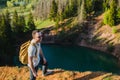 Travel, tourism, adventure, hike and people concept - bearded man with backpack hiking in forest and breathes pure air