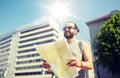 Man traveling with backpack and map in city Royalty Free Stock Photo