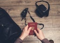 Travel and tourism and business trip concept. Man sitting ready holding Russian travel passport in hands with leather bag and Royalty Free Stock Photo