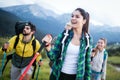 Travel, tourism, hike, gesture and people concept - group of smiling friends with backpacks Royalty Free Stock Photo