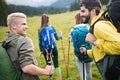 Travel, tourism, hike, gesture and people concept - group of smiling friends with backpacks Royalty Free Stock Photo