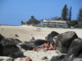 Travel and Tourism - Magical beach encrusted with beautiful breezy palm trees and volcanic rocks, Coolangatta Qld Australia