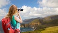 Woman with backpack and camera at big sur coast Royalty Free Stock Photo