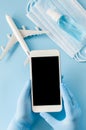 Travel and Tourism Planning after Coronavirus and Quarantine. Hands in disposable gloves hold smartphone. Royalty Free Stock Photo