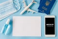 Travel and Tourism Planning after Quarantine. Smartphone with airplane model, passports, face mask and sanitizer Royalty Free Stock Photo